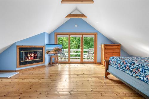 a bedroom with a bed and a fireplace at Aqua Breeze in Union Pier