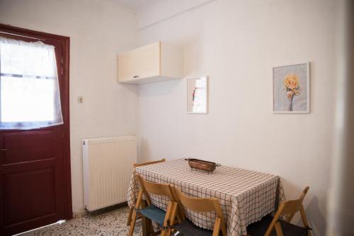 a room with a table and chairs and a door at Hestia in Mouresi