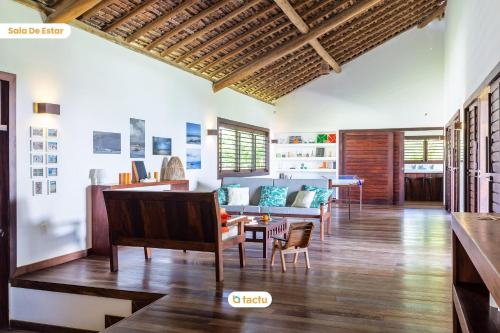 a living room with a couch and a table at Casa da Praia, mansão à beira mar no Fortim in Maceio