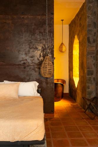 a bedroom with a bed and a tub in it at Casa Trujillo in Capilla de Guadalupe