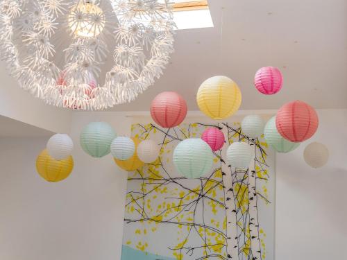 a bunch of colorful paper lanterns hanging from a ceiling at Woodend Barn in Auchterarder