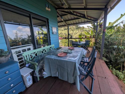 a table on the porch of a house at Case entre2containers in LʼEntre-Deux