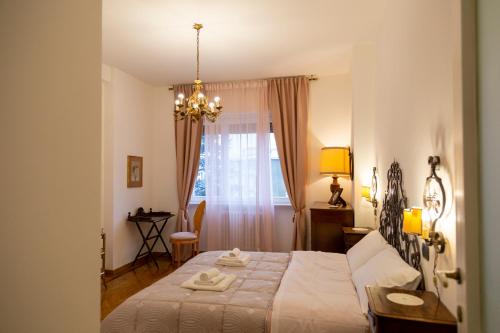 a bedroom with a bed and a chandelier at Casa Angelika near Milan, Malpensa, Rho Fiera in Legnano