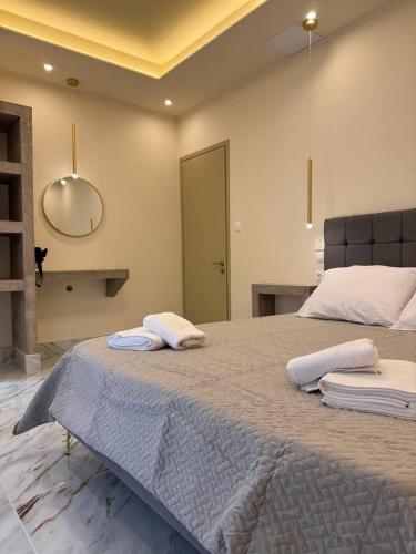 a bedroom with a large bed with two towels on it at Villa Sunlight Sidari in Sidari