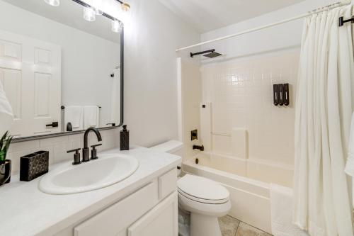 a white bathroom with a sink and a toilet at 7 Mi to Dtwn Charming Retreat with Yard in Boise in Boise