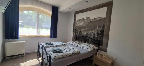 En eller flere senge i et værelse på Rezydencja Pod Giewontem