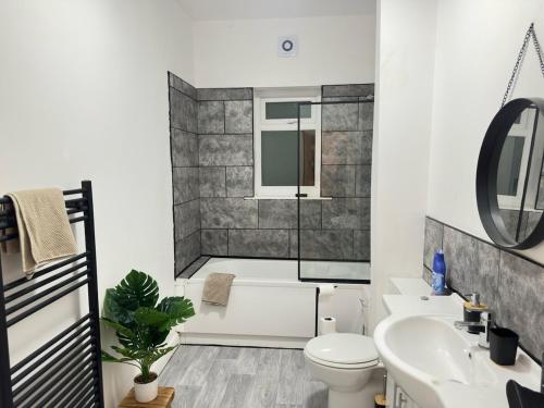 a bathroom with a shower and a toilet and a sink at 3 BD Luxury Stay For Contractors & Families in Newcastle upon Tyne