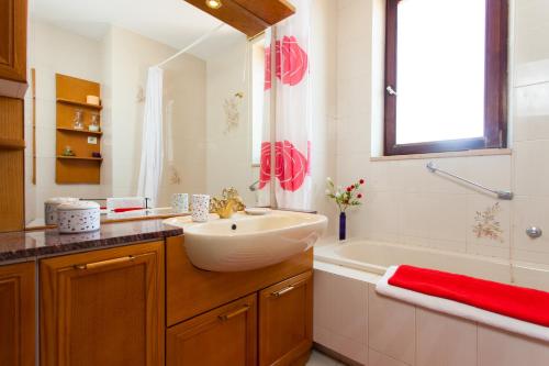 a bathroom with a white sink and a tub and a sink at Premium Central Apartments in Vrsar