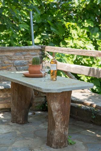a table with two wine glasses and a bottle on it at Hestia in Mouresi