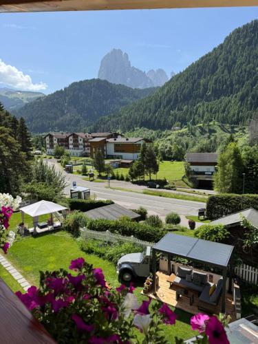a view from the balcony of a house with flowers at Hotel Brunello in Ortisei