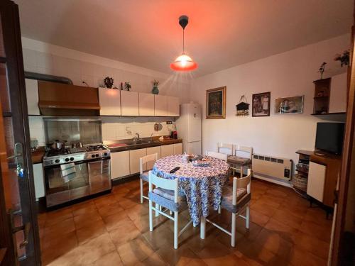 a kitchen with a table with a table cloth on it at Case vacanze Efisio e Vilma in Santa Giusta
