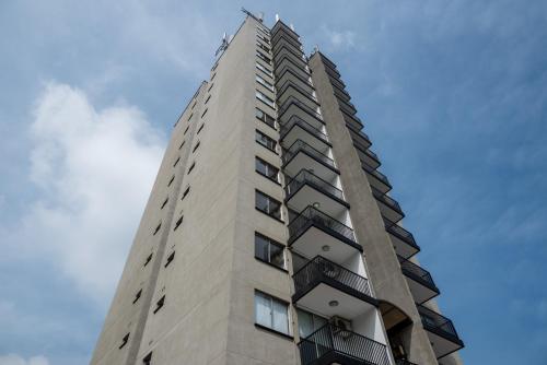 a tall building with balconies on top of it at Hotel Santa Ana Medellin in Medellín