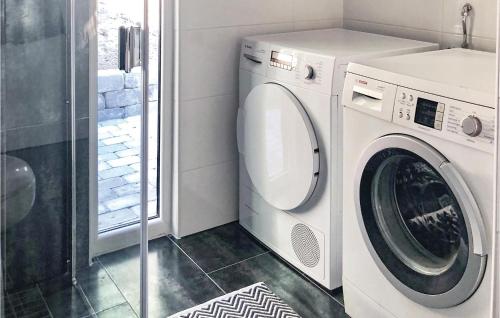 a laundry room with a washing machine and a shower at Amazing Home In Borås With Wifi in Borås
