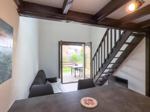 a dining room with a table and chairs and a staircase at Atlantic Selection - La Lorada, à deux pas du port in Capbreton