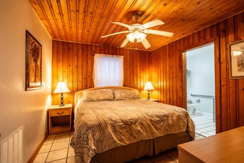 a bedroom with a bed and a ceiling fan at Atlantic Winds Condos in Myrtle Beach