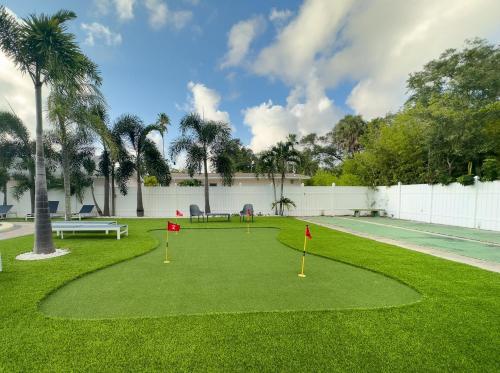 a golf course with red flags in the grass at 1 King Bed Unit With Shared Pool in Clearwater