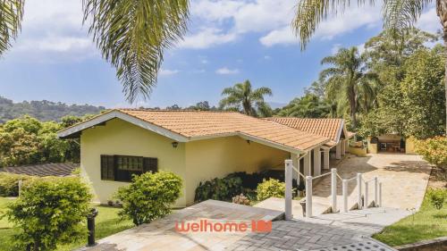 a house with a tile roof at Casa de campo em Atibaia com Lareira e Piscina in Atibaia