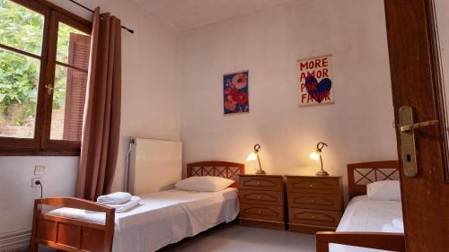 a bedroom with two beds and a window at Hestia in Mouresi