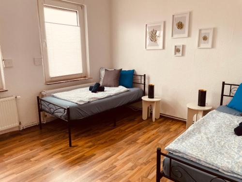 a room with two beds and a window at Gästehaus Sina in Wilhelmshaven