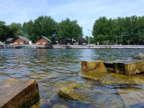 a large body of water with rocks in the water at Safaritent 2 in Biddinghuizen