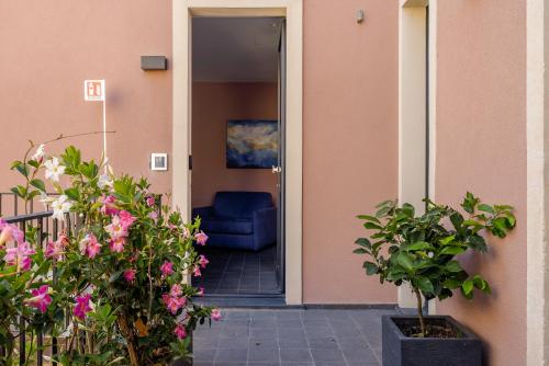 a blue chair sitting inside of a house with flowers at Creuza De Ma in Riposto
