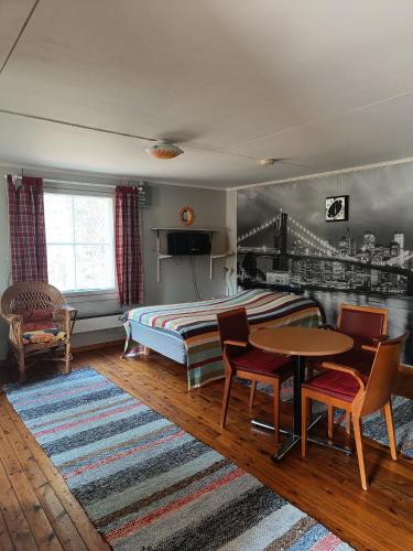 a bedroom with a bed and a table and chairs at Lomakylä Lapponia in Inari