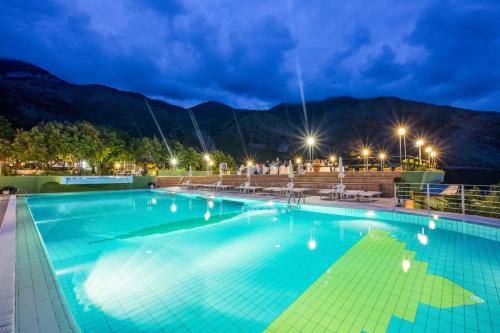 a pool on a cruise ship at night at Hotel Club San Diego in Maratea