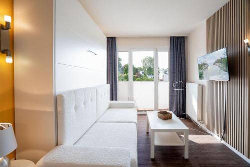 Postel nebo postele na pokoji v ubytování Das Solaris 18 Beach Apartment mit Gemeinschaftssauna und Grillplatz