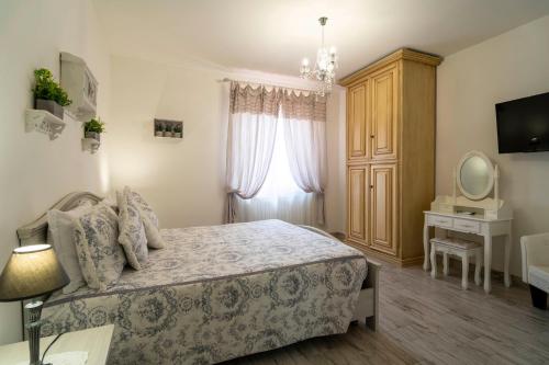 a bedroom with a bed and a dresser and a mirror at Agriturismo Corte degli Angeli in Marina di Grosseto