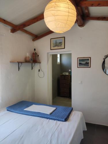 a room with a bed with a blue blanket on it at Myrovolos in Armenistis
