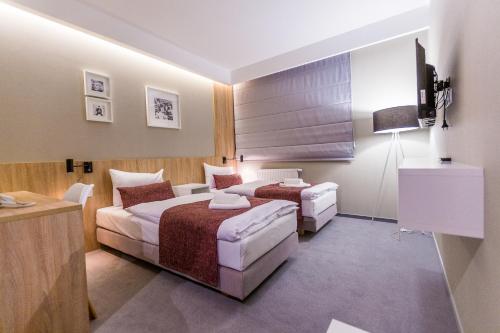 Voodi või voodid majutusasutuse Hotel Falcon toas