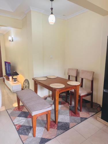 a dining room with a wooden table and chairs at In arusha nests in Arusha