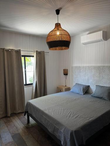 a bedroom with a bed and a pendant light at Balsamaris in Manta Rota