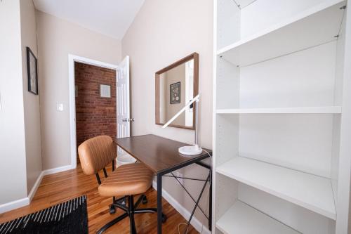 a home office with a desk and a chair at Sunny 4BR/2BA Retreat in Morningside Heights, NYC in New York