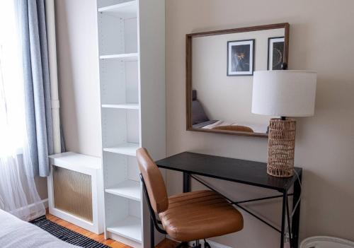 a bedroom with a desk and a mirror and a chair at Sunny 4BR/2BA Retreat in Morningside Heights, NYC in New York