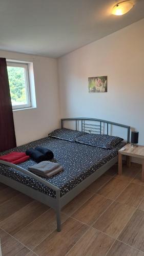 a large bed in a room with a table at Dejan Apartments-Top centar-Old town-Low budget Studios in Pula