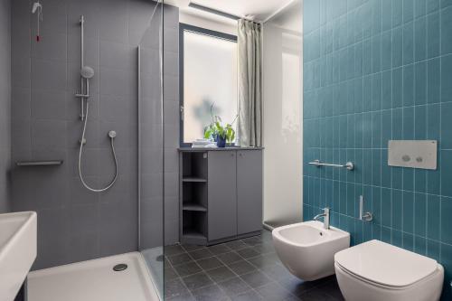 a bathroom with a toilet and a sink at Creuza De Ma in Riposto