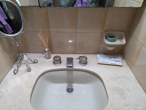 a bathroom with a white sink and a mirror at Tolouse 1 in Tolosa