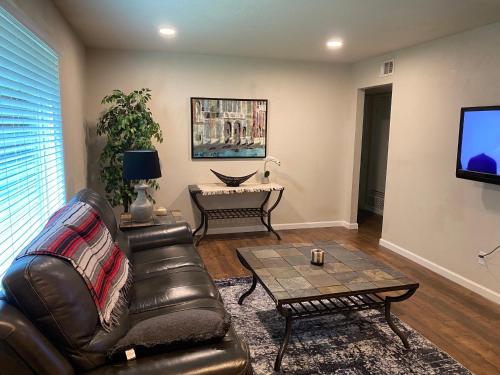 a living room with a leather couch and a coffee table at 2bd 1bth place in Arlington Centrally located in DFW and conveniently located near Cowboy's Stadium in Arlington