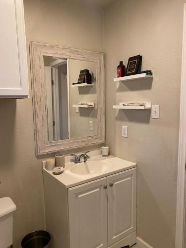 a bathroom with a sink and a mirror at 2bd 1bth place in Arlington Centrally located in DFW and conveniently located near Cowboy's Stadium in Arlington