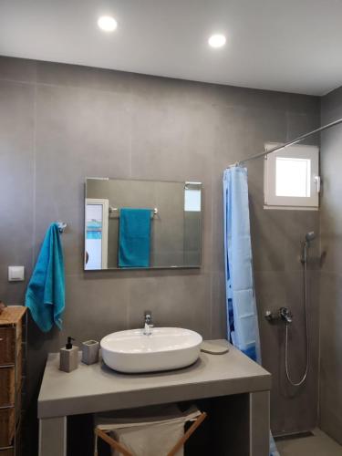 a bathroom with a sink and a shower at Myrovolos in Armenistis