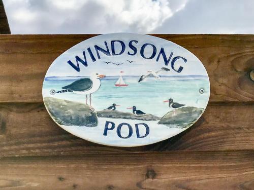 a sign on a wooden wall with birds on it at Windsong in Theddlethorpe Saint Helen