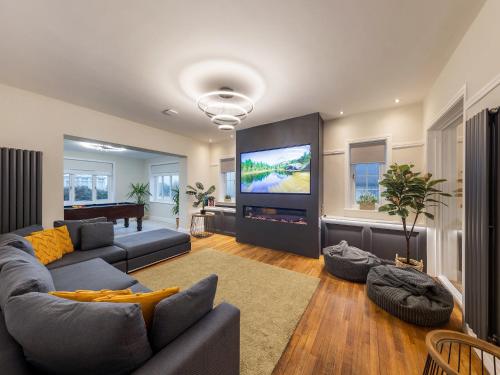 a living room with a couch and a flat screen tv at Bryndedwydd in Borth