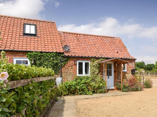 a brick cottage with an orange roof at The Old Paybarn - Uk39378 in Snettisham