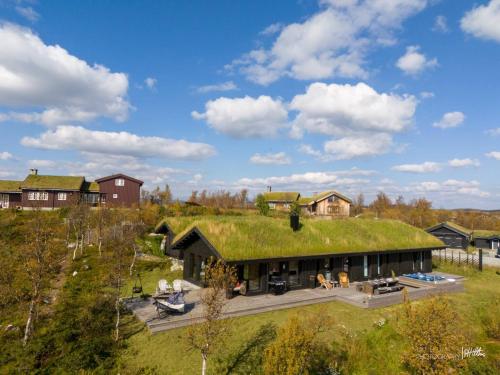 an image of a house with a grass roof at Nydelig og Moderne hytte på Kikut Geilo - 6 senger, 4 soverom og jacuzzi in Geilo