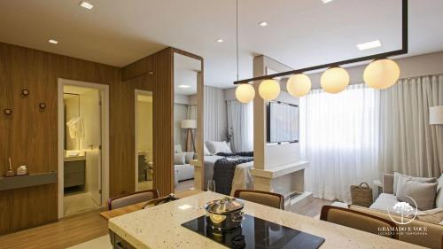 a living room with a kitchen and a room with a living room at Modern apt next to Criamigos Park + coffee Day 1 in Gramado