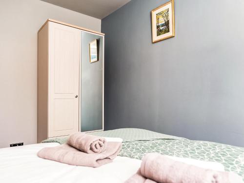 a bedroom with a bed with a towel on it at Plum Tree House in Dore