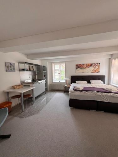 a large bedroom with a bed and a table at Gruppenhaus Harzer Glückauf in Langelsheim