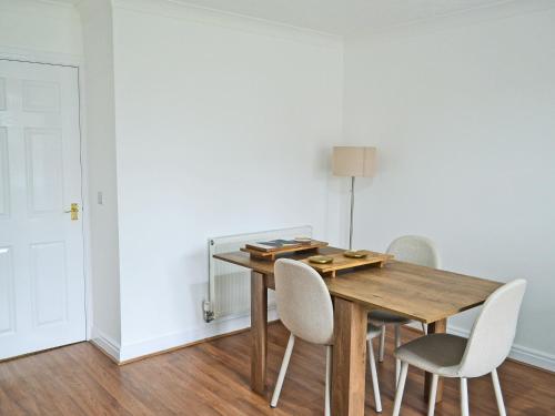 a dining room with a wooden table and chairs at The Townhouse in Gainsborough