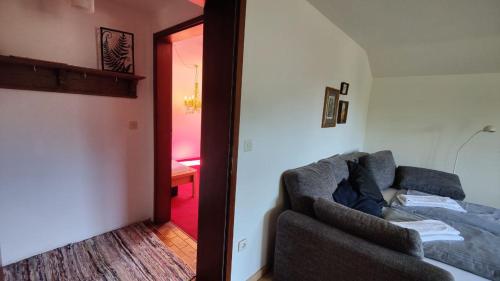 a living room with a couch next to a door at Abendsonne in Saulgrub